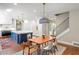 Eat-in kitchen features brick floors, an island with bar seating, and stainless appliances at 5205 Riverview Nw Rd, Atlanta, GA 30327