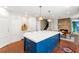Spacious kitchen with large island, modern cabinets, and eat-in dining area with stone fireplace at 5205 Riverview Nw Rd, Atlanta, GA 30327
