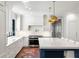 A modern kitchen features a large island with bar seating, stainless appliances, and white cabinets at 5205 Riverview Nw Rd, Atlanta, GA 30327