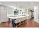 Spacious kitchen with a large island, white cabinetry, and brick flooring at 5205 Riverview Nw Rd, Atlanta, GA 30327