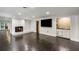 Open-concept living room featuring fireplace and built-in bar at 5205 Riverview Nw Rd, Atlanta, GA 30327
