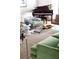 Stylish living room with green sofa, patterned chairs, grand piano, and decorative coffee table, perfect for relaxation and entertainment at 5205 Riverview Nw Rd, Atlanta, GA 30327