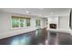 Spacious living room with fireplace and large windows providing ample natural light at 5205 Riverview Nw Rd, Atlanta, GA 30327