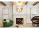 Bright living room featuring fireplace, piano, artwork, and modern lighting fixture at 5205 Riverview Nw Rd, Atlanta, GA 30327
