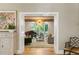 Living room featuring fireplace, piano, exposed wood beams, and modern lighting fixture at 5205 Riverview Nw Rd, Atlanta, GA 30327