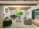 Elegant living room featuring fireplace, piano, exposed wood beams, and modern lighting fixture at 5205 Riverview Nw Rd, Atlanta, GA 30327