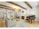 Open concept living room with wood beams, fireplace, built ins, and hardwood floors at 5205 Riverview Nw Rd, Atlanta, GA 30327