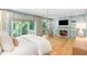 Serene main bedroom with a fireplace, built-in shelves, large windows, and access to a private balcony at 5205 Riverview Nw Rd, Atlanta, GA 30327