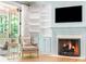 Cozy sitting area with fireplace and built-in shelving in main bedroom, with a hanging chair on a private patio at 5205 Riverview Nw Rd, Atlanta, GA 30327