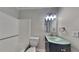 Bathroom includes a shower-tub, toilet, vanity with sink and decorative lighting at 5429 Martins Crossing Rd, Stone Mountain, GA 30088