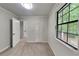 Bright bedroom featuring neutral carpet, a window offering natural light, and a closet for storage at 5429 Martins Crossing Rd, Stone Mountain, GA 30088