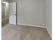 Bedroom showcases neutral carpet, light paint, a white door, and a tranquil atmosphere at 5429 Martins Crossing Rd, Stone Mountain, GA 30088