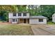 Charming split-level home featuring stone accents, a well-manicured lawn, and a classic, inviting facade at 5429 Martins Crossing Rd, Stone Mountain, GA 30088