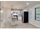 Modern kitchen with white cabinetry, stainless steel appliances, and a convenient island for meal prep at 5429 Martins Crossing Rd, Stone Mountain, GA 30088