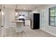 Well-lit kitchen featuring white cabinetry, granite countertops, and a stylish island with pendant lighting at 5429 Martins Crossing Rd, Stone Mountain, GA 30088