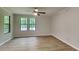 Bright living room with hardwood floors, large windows, and neutral paint perfect for decorating to your style at 5429 Martins Crossing Rd, Stone Mountain, GA 30088