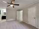 Inviting primary bedroom featuring plush carpeting, ceiling fan, and access to an ensuite bathroom at 5429 Martins Crossing Rd, Stone Mountain, GA 30088