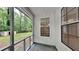 Relaxing screened-in porch, perfect for enjoying the outdoors with windows and a backyard view at 5429 Martins Crossing Rd, Stone Mountain, GA 30088