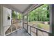 Enclosed porch overlooking a spacious backyard and view of the natural landscape at 5429 Martins Crossing Rd, Stone Mountain, GA 30088