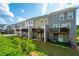 Backyard view of townhomes featuring decks, patios, and lush green grass at 6294 Century Park Se Pl, Mableton, GA 30126
