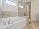 Luxurious soaking tub and separate tiled shower with glass door at 6294 Century Park Se Pl, Mableton, GA 30126