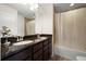 Bathroom with double sinks, granite countertops, and tiled shower with a tub at 6294 Century Park Se Pl, Mableton, GA 30126