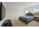 Bedroom with a queen-sized bed, large window, and neutral-toned walls and carpet at 6294 Century Park Se Pl, Mableton, GA 30126