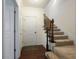 Foyer with hardwood floors, staircase with iron spindles, and access to closet space at 6294 Century Park Se Pl, Mableton, GA 30126