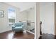 Sunlit upper hallway with stylish chair and wrought iron railing at 6294 Century Park Se Pl, Mableton, GA 30126