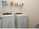Laundry room with a white washer and dryer, and wire shelving for storage at 6294 Century Park Se Pl, Mableton, GA 30126