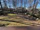 This expansive backyard features a shed and ample space for outdoor activities, partially fenced at 6542 Cherry Tree Ln, Atlanta, GA 30328