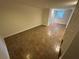 Finished basement space with tiled floor, bright lighting and a closet at 6542 Cherry Tree Ln, Atlanta, GA 30328