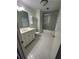 Bathroom with white tile, shower with glass door, and a vanity with storage at 6542 Cherry Tree Ln, Atlanta, GA 30328