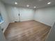 Bright, minimalist bedroom with hardwood floors, recessed lighting, and a large window at 6542 Cherry Tree Ln, Atlanta, GA 30328