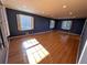 Bedroom featuring hardwood floors and natural light from the three windows at 6542 Cherry Tree Ln, Atlanta, GA 30328