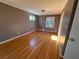 Bedroom featuring hardwood floors, two windows, and a closet at 6542 Cherry Tree Ln, Atlanta, GA 30328