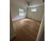 Well-lit bedroom with ceiling fan, natural light, and hardwood floors at 6542 Cherry Tree Ln, Atlanta, GA 30328
