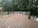 Large wooden deck featuring white railings and stairs, ideal for entertaining at 6542 Cherry Tree Ln, Atlanta, GA 30328