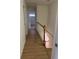 Upstairs hallway with hardwood floors and staircase with wooden banister at 6542 Cherry Tree Ln, Atlanta, GA 30328