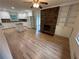 Open kitchen featuring modern appliances, an island, and a brick fireplace at 6542 Cherry Tree Ln, Atlanta, GA 30328