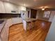 Kitchen with granite countertops, island, and hardwood floors at 6542 Cherry Tree Ln, Atlanta, GA 30328