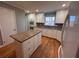 Kitchen with granite countertops, island, and hardwood floors at 6542 Cherry Tree Ln, Atlanta, GA 30328