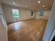 Large living room area with hardwood flooring and three windows that provide plenty of natural light at 6542 Cherry Tree Ln, Atlanta, GA 30328