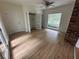 Cozy living room area with hardwood flooring, brick fireplace and built-ins, as well as a large window at 6542 Cherry Tree Ln, Atlanta, GA 30328