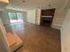Finished basement living room features tiled floor, brick fireplace with built-ins, and sliding glass door to the outside at 6542 Cherry Tree Ln, Atlanta, GA 30328