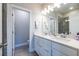 Bright bathroom featuring a double vanity with white cabinets and quartz countertops, and tiled shower at 2048 Rockledge Ne Rd, Atlanta, GA 30324