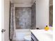 Well-maintained bathroom featuring a tiled tub, modern toilet, vanity with a stylish sink and fixtures at 2048 Rockledge Ne Rd, Atlanta, GA 30324
