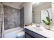 Bathroom featuring a bathtub with tiled surround, vanity with a vessel sink, and modern fixtures at 2048 Rockledge Ne Rd, Atlanta, GA 30324