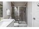 Tiled shower with glass door, white vanity, and neutral walls in this well-lit bathroom at 2048 Rockledge Ne Rd, Atlanta, GA 30324