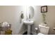 Clean powder room with pedestal sink, oval mirror, and neutral decor at 2048 Rockledge Ne Rd, Atlanta, GA 30324